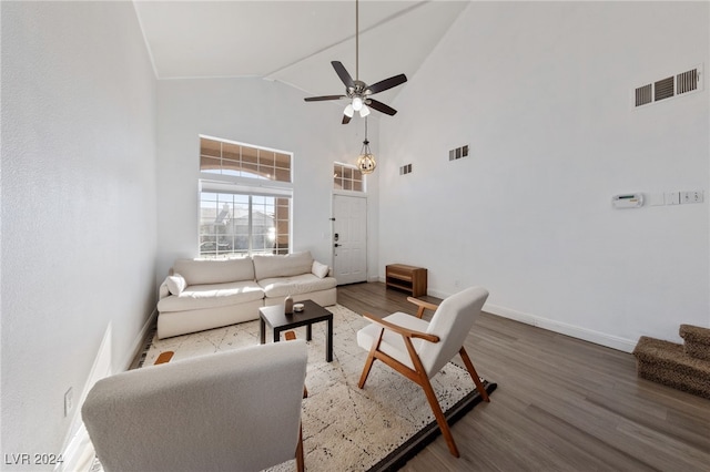 living room featuring wood-type flooring, high vaulted ceiling, and ceiling fan