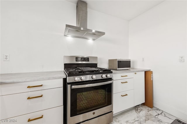 kitchen with white cabinets, stainless steel range with gas cooktop, and wall chimney range hood