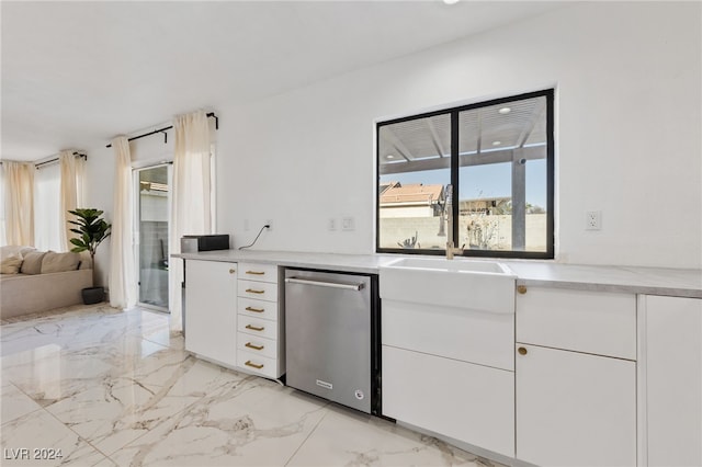 kitchen with dishwasher, white cabinetry, plenty of natural light, and sink