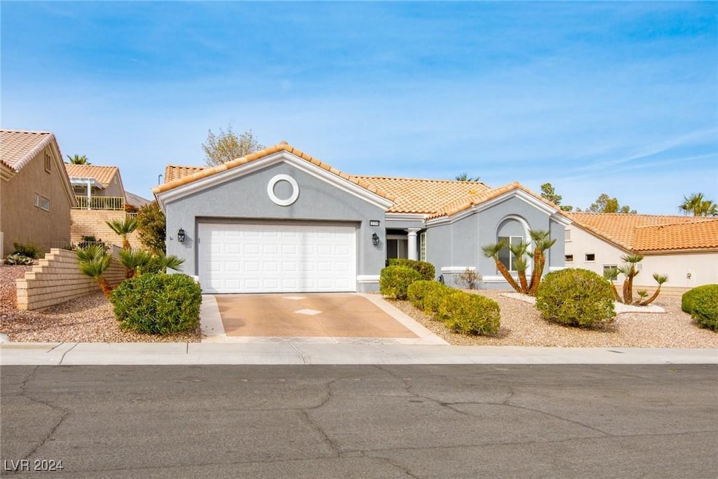 mediterranean / spanish house with a garage