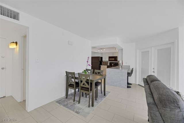 tiled dining room with french doors