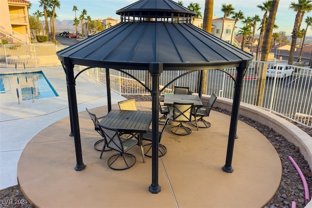 view of patio featuring a gazebo and a community pool