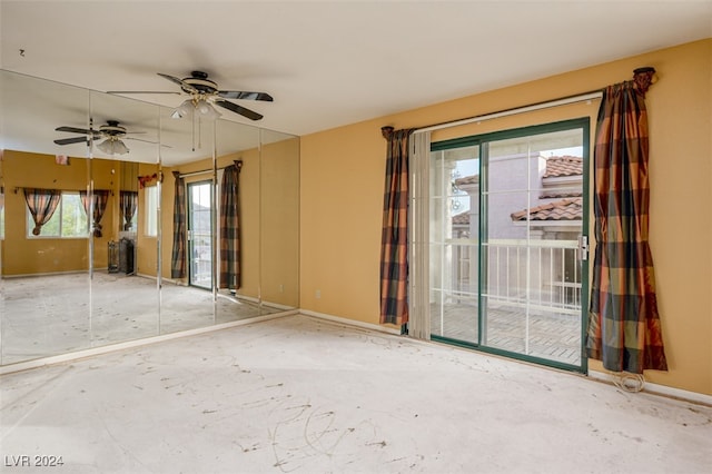 empty room featuring ceiling fan and concrete floors