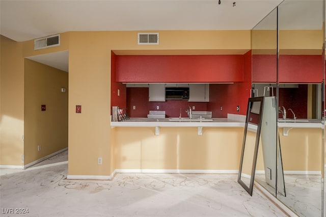 kitchen with a breakfast bar area and kitchen peninsula