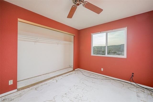 unfurnished bedroom with a closet and ceiling fan