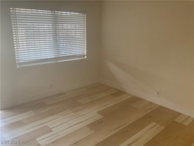 spare room with light hardwood / wood-style flooring and a healthy amount of sunlight