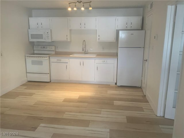 kitchen featuring white cabinets, white appliances, light hardwood / wood-style flooring, and sink