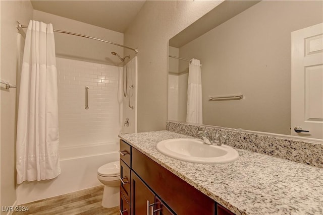 full bathroom featuring shower / bath combo with shower curtain, vanity, wood-type flooring, and toilet