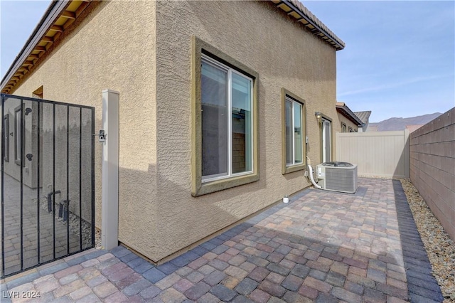 view of side of home with cooling unit and a patio area