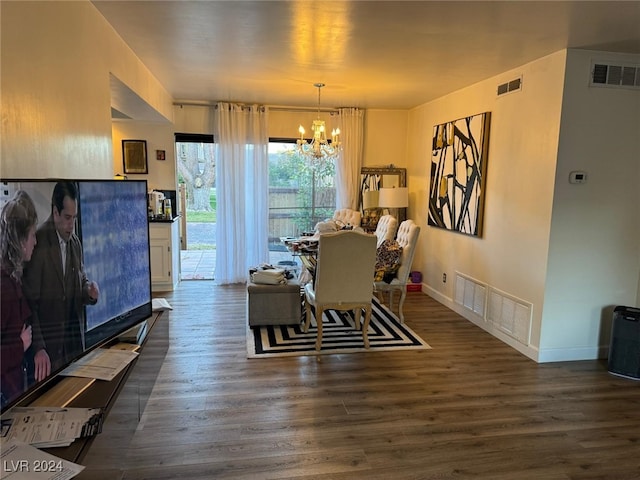 dining room featuring dark hardwood / wood-style flooring and a notable chandelier