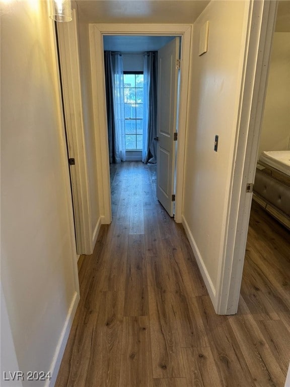 hallway with dark hardwood / wood-style floors