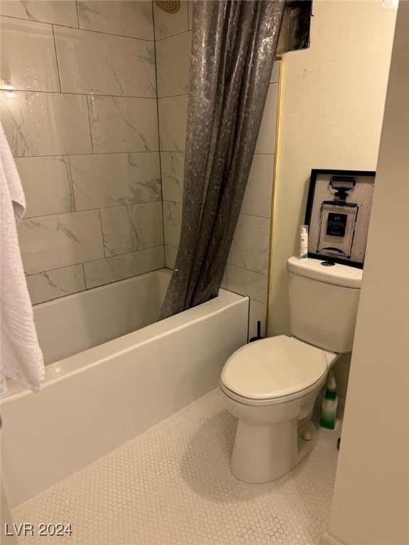 bathroom featuring tile patterned floors, shower / tub combo with curtain, and toilet