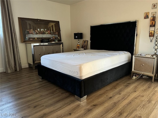 bedroom with wood-type flooring