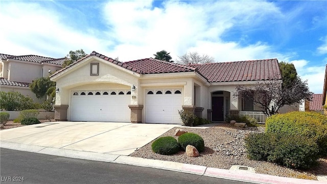 mediterranean / spanish-style home with a garage