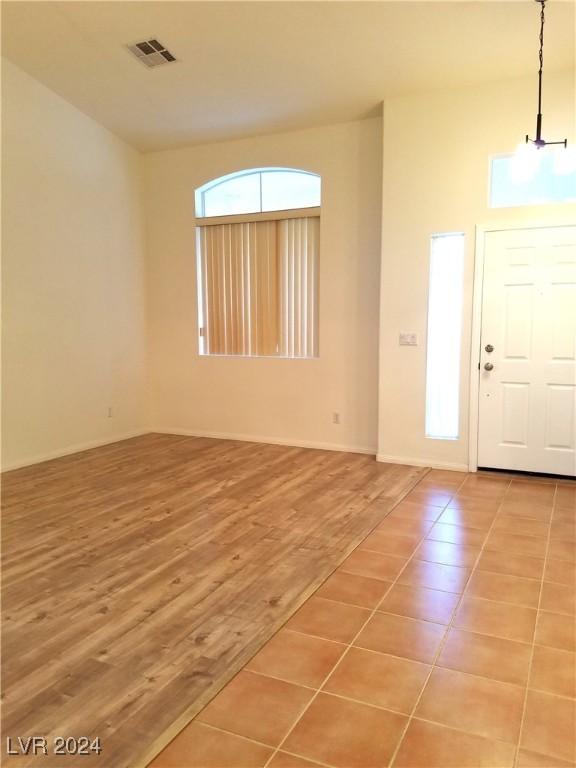 entrance foyer featuring hardwood / wood-style floors and an inviting chandelier