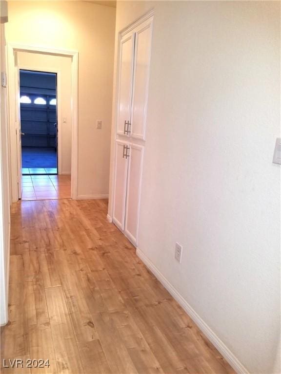 corridor with light hardwood / wood-style floors