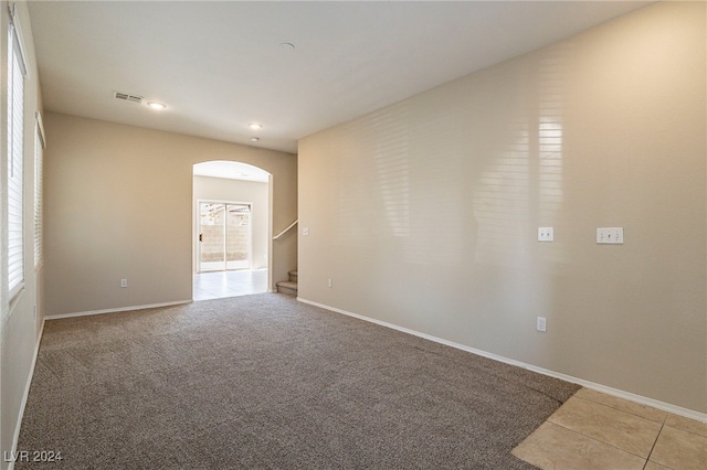 spare room with light colored carpet