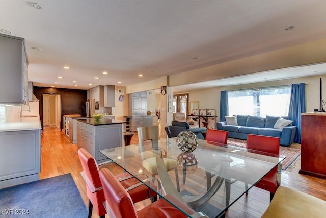 dining space with sink and light hardwood / wood-style floors