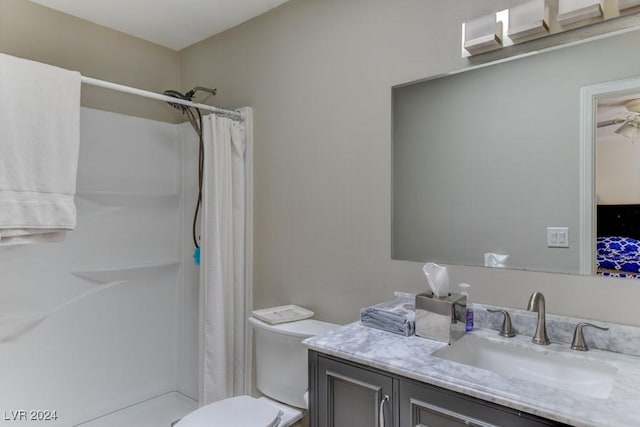 bathroom with vanity, curtained shower, and toilet