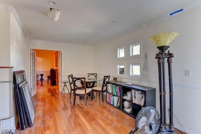 interior space with crown molding and light hardwood / wood-style flooring