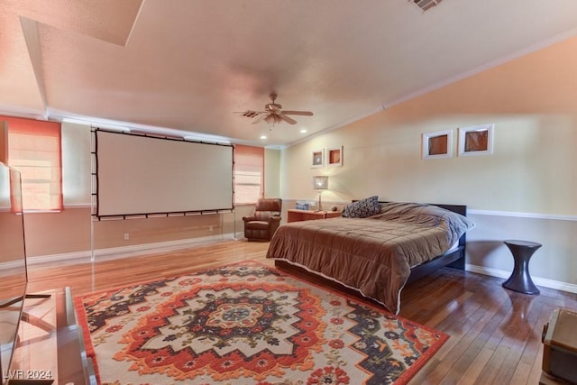 bedroom featuring hardwood / wood-style flooring, ornamental molding, and vaulted ceiling