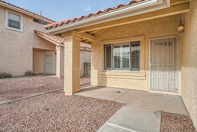 entrance to property with a patio