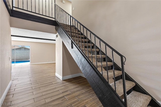 staircase with wood-type flooring