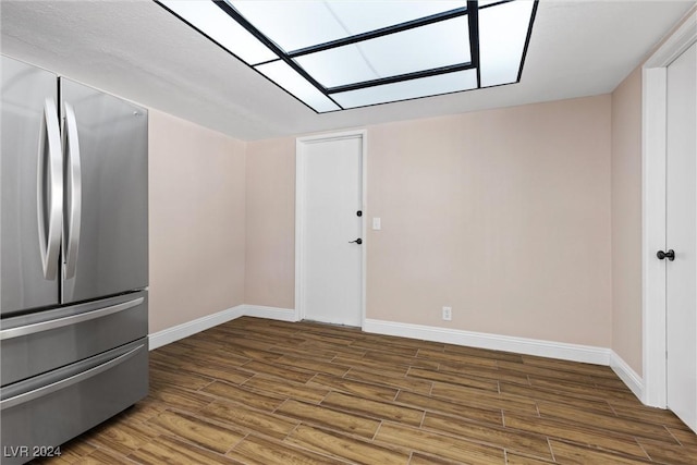 kitchen featuring stainless steel refrigerator and dark hardwood / wood-style floors