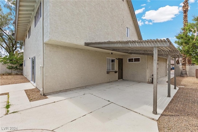 rear view of house with a patio area and a pergola