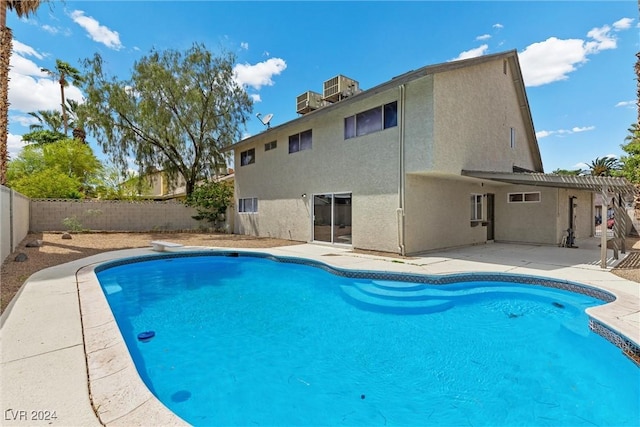 view of swimming pool featuring a diving board and a patio area