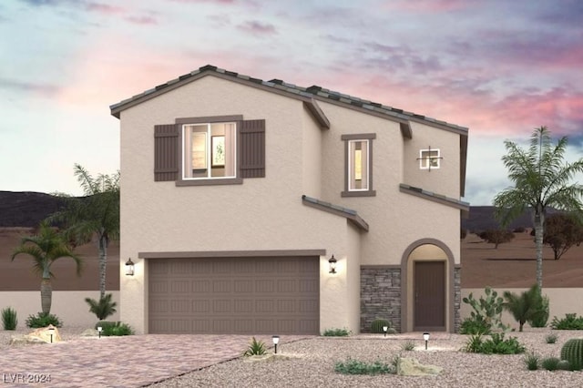 9865 Lost Horse Ave, Las Vegas, NV 89178 - view of front of house with a garage, stucco siding, decorative driveway, and stone siding