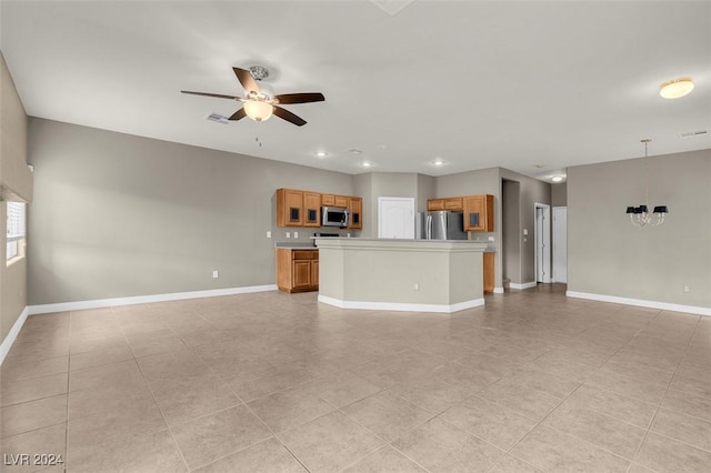 unfurnished living room featuring light tile patterned floors and ceiling fan with notable chandelier