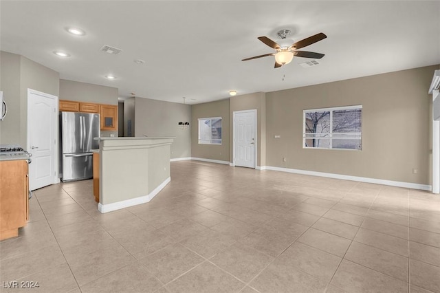 interior space featuring light tile patterned floors and ceiling fan