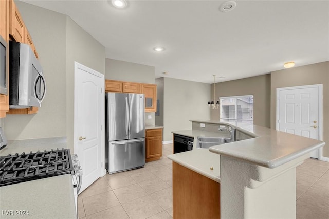 kitchen featuring sink, light tile patterned floors, a kitchen island with sink, stainless steel appliances, and decorative light fixtures