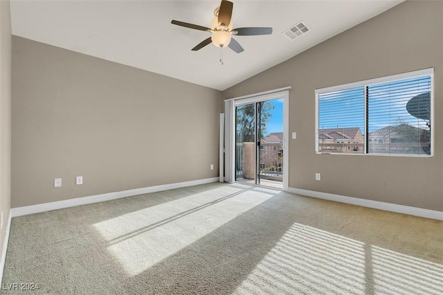 carpeted empty room featuring vaulted ceiling and ceiling fan