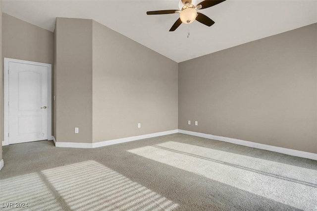 carpeted spare room with vaulted ceiling and ceiling fan