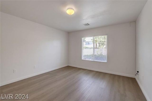 spare room with hardwood / wood-style flooring