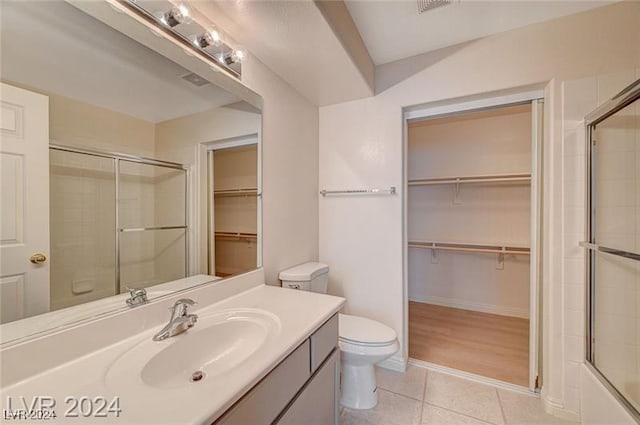 full bathroom featuring tile patterned flooring, vanity, enclosed tub / shower combo, and toilet