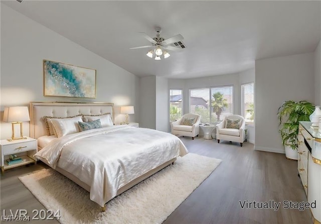 bedroom featuring ceiling fan, wood-type flooring, and lofted ceiling