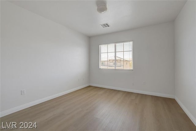 spare room with hardwood / wood-style floors