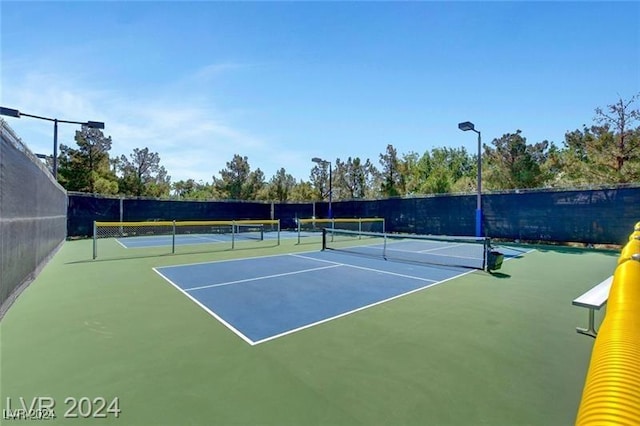 view of tennis court featuring basketball court