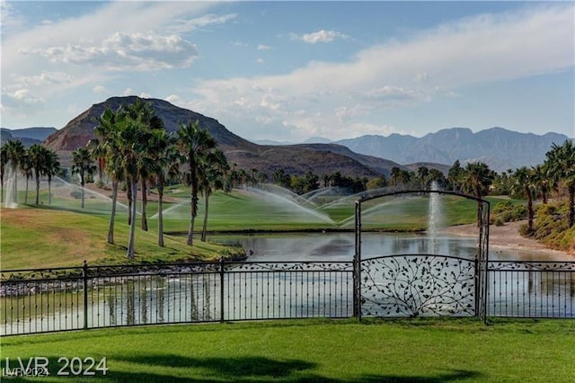 view of home's community with a lawn and a water and mountain view