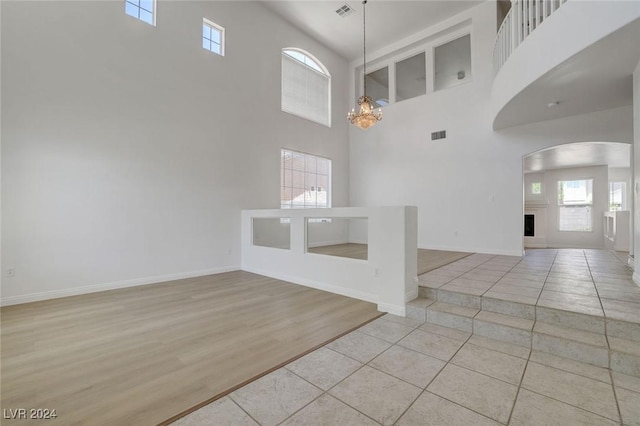 tiled foyer with a chandelier and a high ceiling