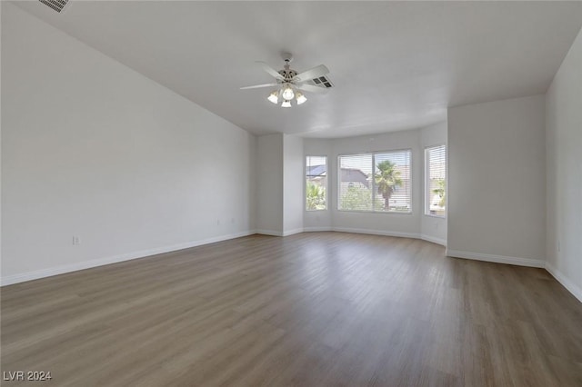 empty room with ceiling fan and hardwood / wood-style flooring