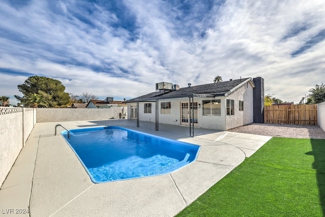 view of swimming pool featuring french doors and a patio area