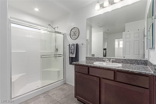 bathroom featuring tile patterned floors, vanity, and an enclosed shower