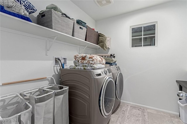 clothes washing area with separate washer and dryer and light tile patterned floors