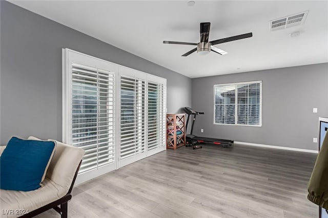 sitting room with ceiling fan, light hardwood / wood-style flooring, and a healthy amount of sunlight