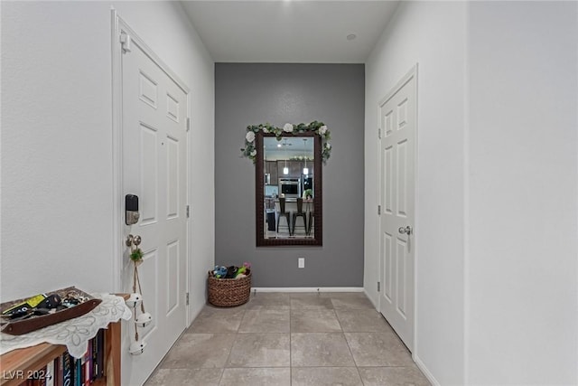 corridor featuring light tile patterned flooring