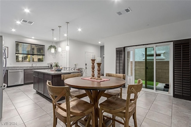 dining area featuring sink, plenty of natural light, and light tile patterned flooring